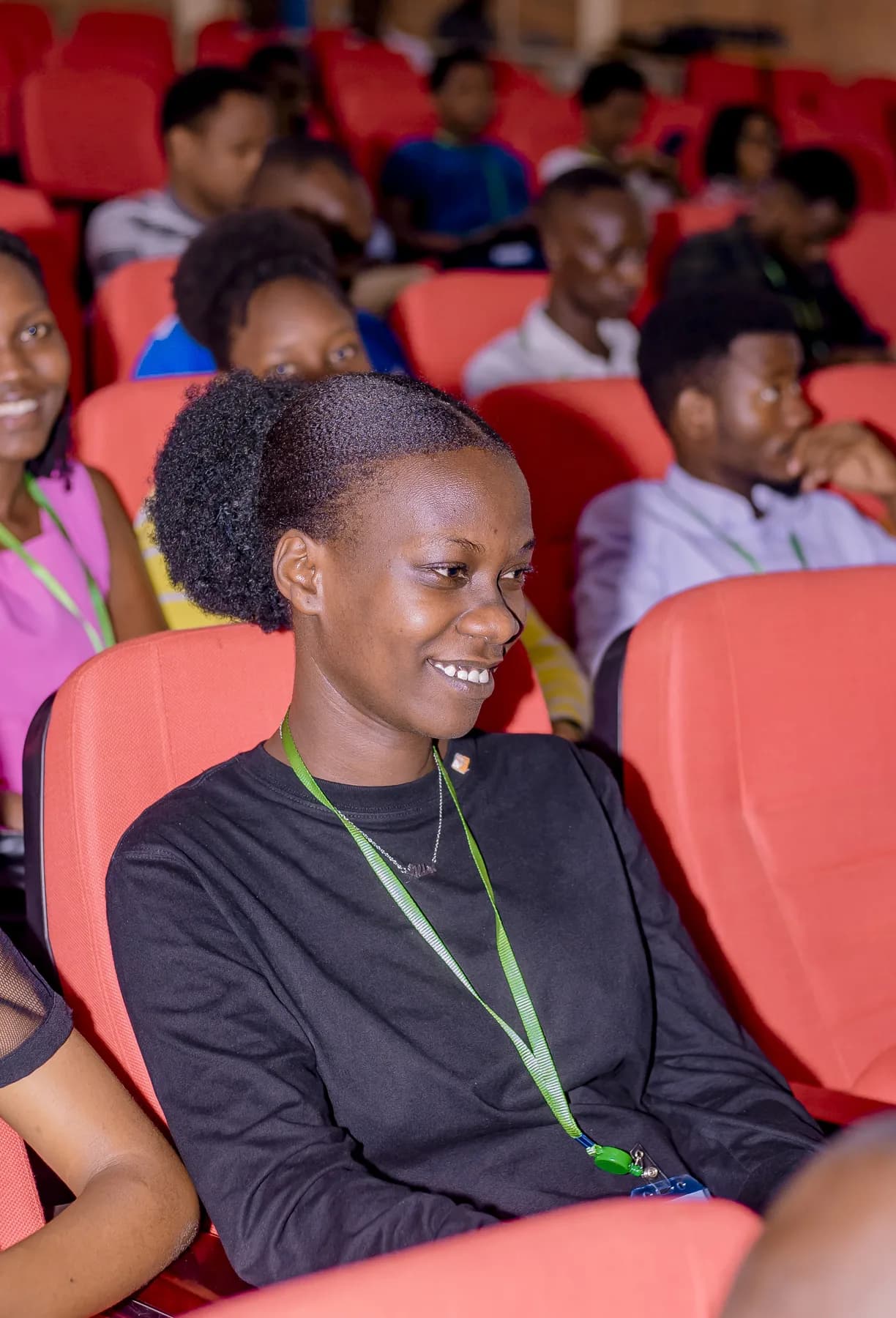 A participant smiling during an IndabaX Burundi gathering in 2025